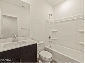 full bathroom featuring shower / washtub combination, vanity, and toilet