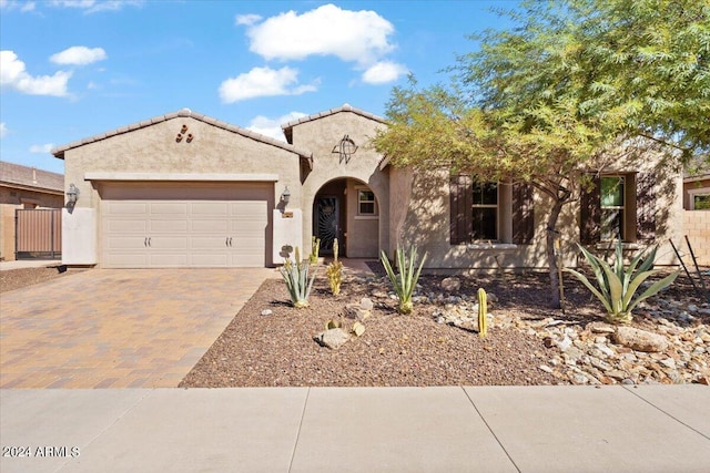 11856 W Lone Tree Trl, Peoria, AZ 85383 - mediterranean / spanish-style house featuring decorative driveway, an attached garage, and stucco siding