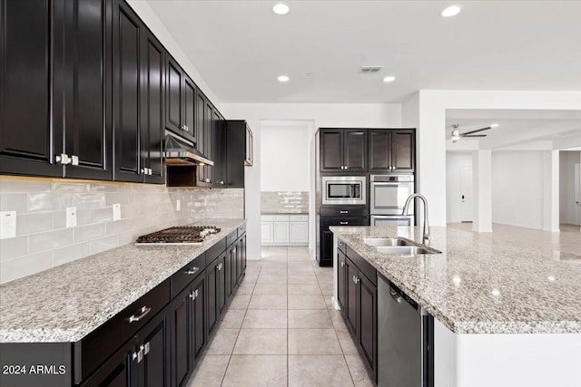 kitchen featuring light tile patterned flooring, sink, appliances with stainless steel finishes, tasteful backsplash, and ceiling fan