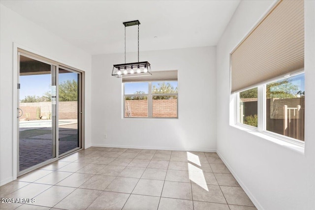 unfurnished dining area featuring light tile patterned floors