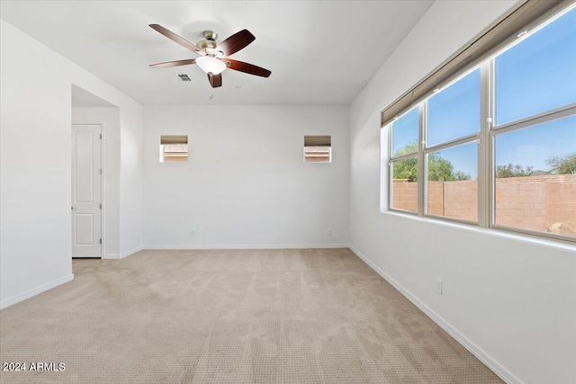 spare room with light carpet and ceiling fan