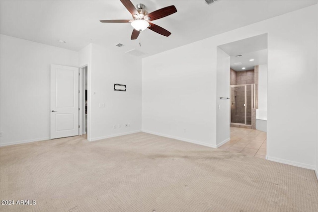 carpeted spare room featuring ceiling fan