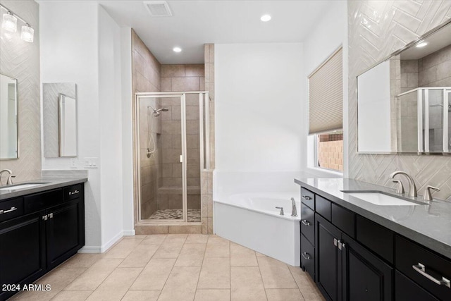 bathroom with shower with separate bathtub, tile patterned floors, and vanity