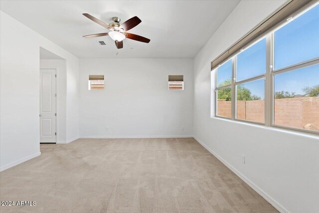 11856 W Lone Tree Trl, Peoria, AZ 85383 - unfurnished room featuring light colored carpet, ceiling fan, and baseboards