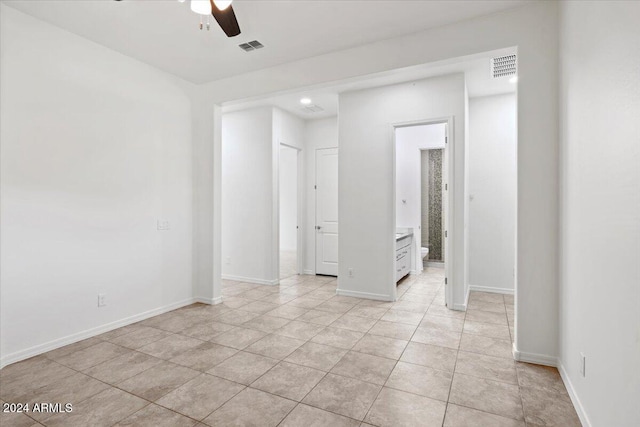 tiled spare room with ceiling fan