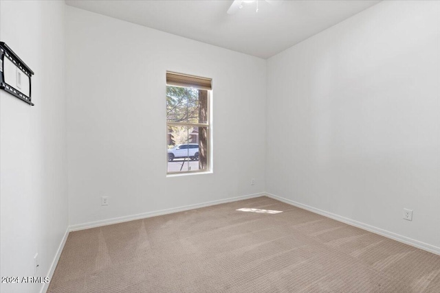 carpeted empty room featuring ceiling fan