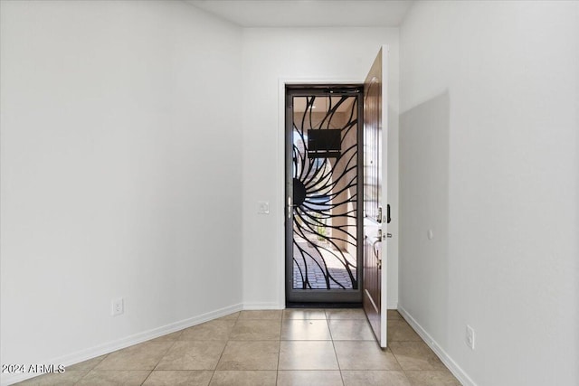 entryway with light tile patterned flooring