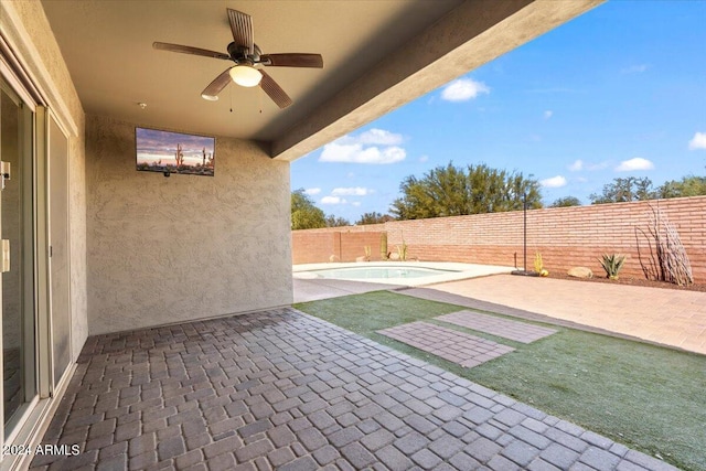 view of patio with a fenced in pool and ceiling fan