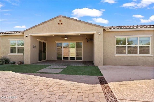 rear view of property with ceiling fan and a patio