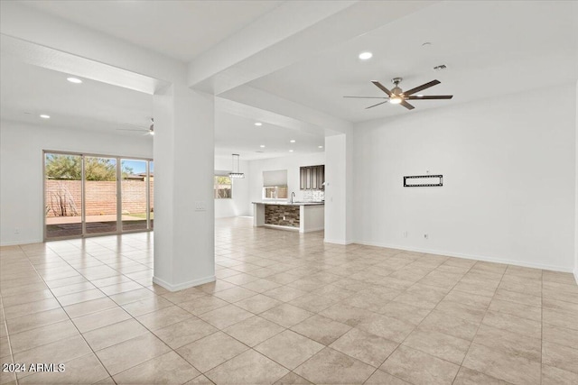 tiled empty room featuring ceiling fan