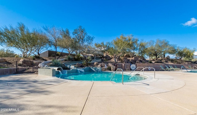 view of pool with a patio and a water slide