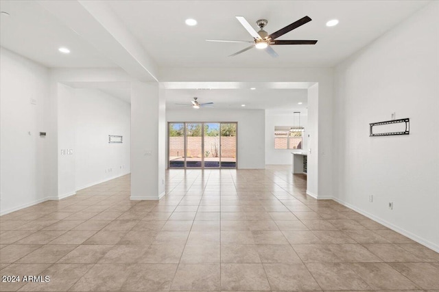 empty room featuring ceiling fan and light tile patterned floors