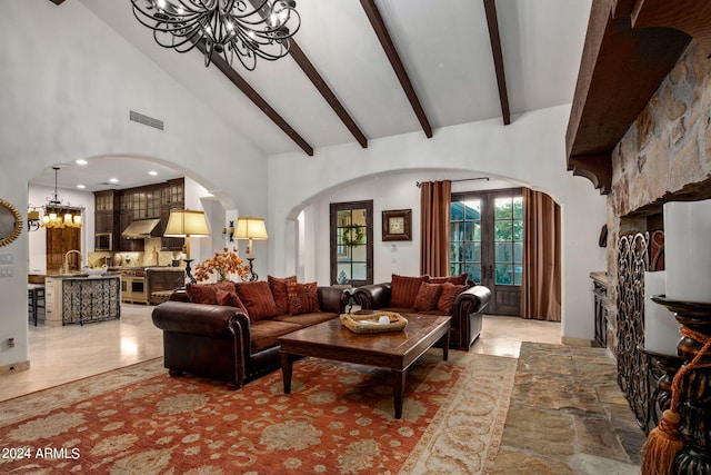 living room featuring an inviting chandelier, beam ceiling, and high vaulted ceiling