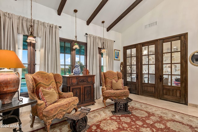 living area with light tile patterned floors, beam ceiling, and high vaulted ceiling