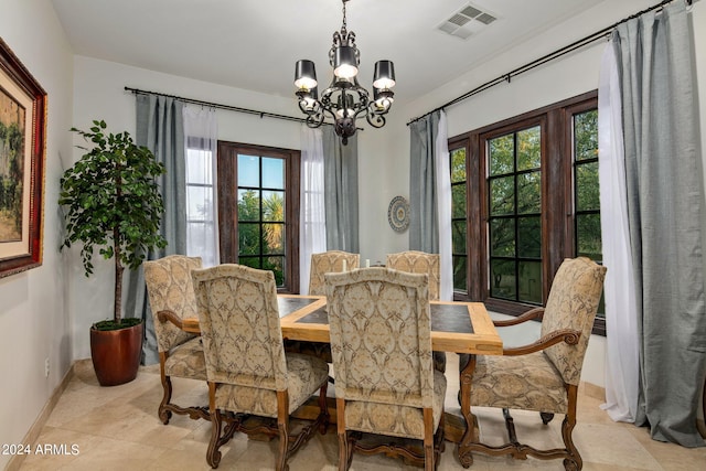 dining area with light tile patterned floors, a chandelier, and a wealth of natural light