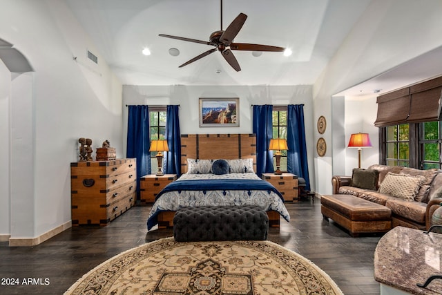 bedroom featuring multiple windows, ceiling fan, and dark wood-type flooring