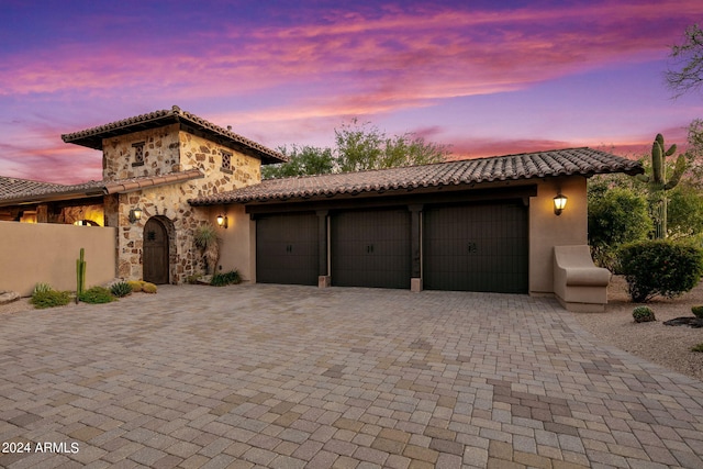 mediterranean / spanish house featuring a garage