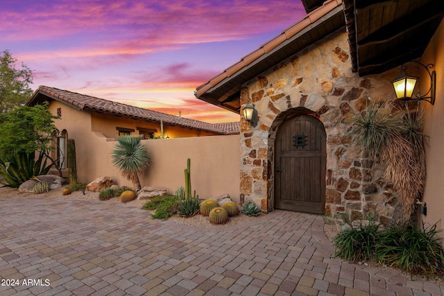 view of exterior entry at dusk