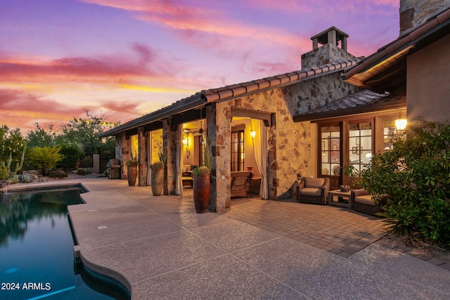 exterior space featuring a patio, an outdoor living space, and french doors