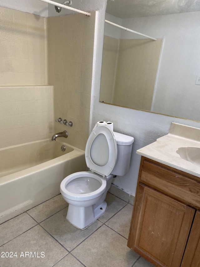 full bathroom with bathing tub / shower combination, tile patterned floors, toilet, and vanity