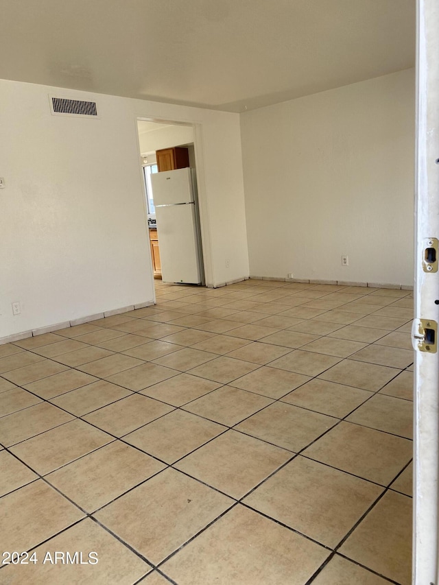 spare room featuring light tile patterned floors