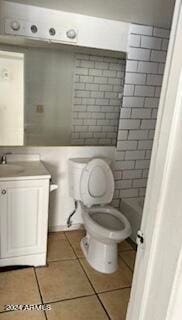 bathroom featuring vanity, toilet, and tile patterned flooring