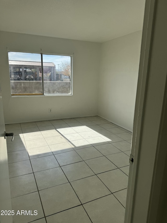 unfurnished room featuring light tile patterned floors