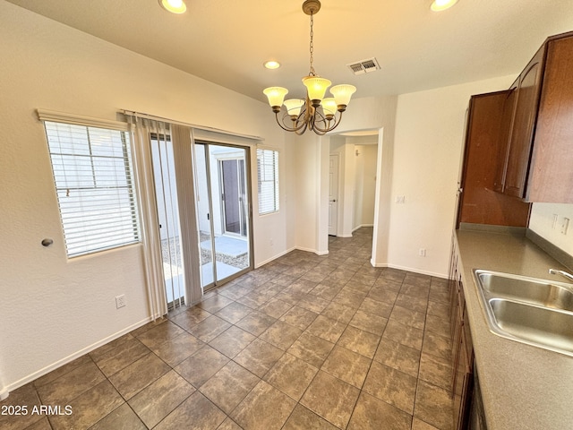 2539 N 148th Dr, Goodyear, AZ 85395 - unfurnished dining area with a sink, a chandelier, recessed lighting, and baseboards