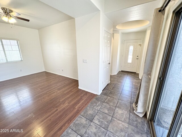 2539 N 148th Dr, Goodyear, AZ 85395 - foyer entrance with plenty of natural light, ceiling fan, dark wood-type flooring, and baseboards