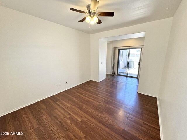 2539 N 148th Dr, Goodyear, AZ 85395 - unfurnished room featuring dark wood-style flooring, a ceiling fan, and baseboards