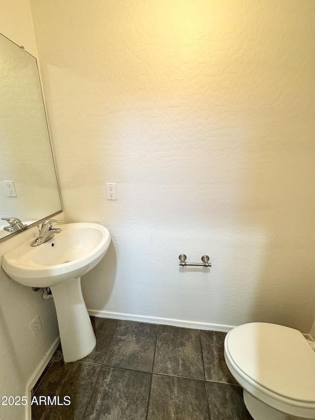 2539 N 148th Dr, Goodyear, AZ 85395 - half bathroom featuring baseboards, tile patterned floors, and toilet