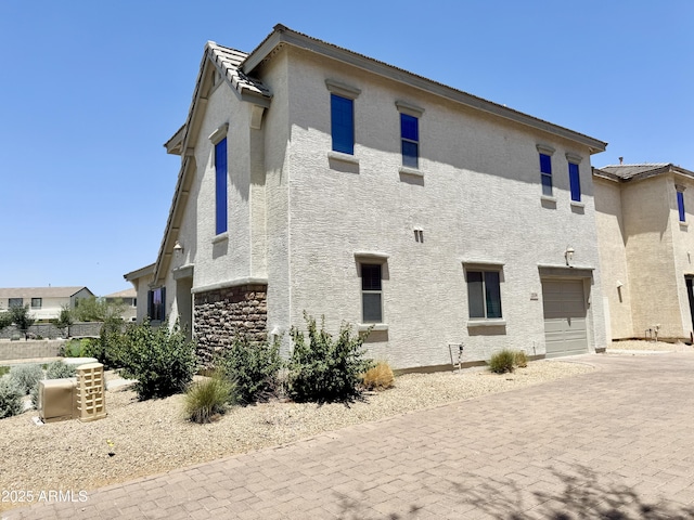 2539 N 148th Dr, Goodyear, AZ 85395 - rear view of property featuring decorative driveway, stucco siding, and a garage