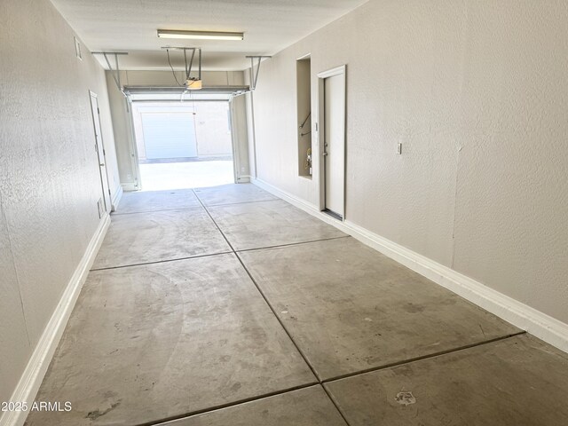 2539 N 148th Dr, Goodyear, AZ 85395 - corridor with concrete flooring, baseboards, and a textured wall