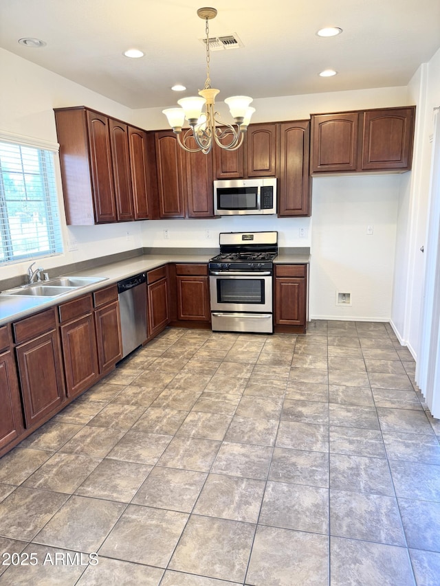 2539 N 148th Dr, Goodyear, AZ 85395 - kitchen featuring appliances with stainless steel finishes, a sink, a chandelier, pendant lighting, and recessed lighting