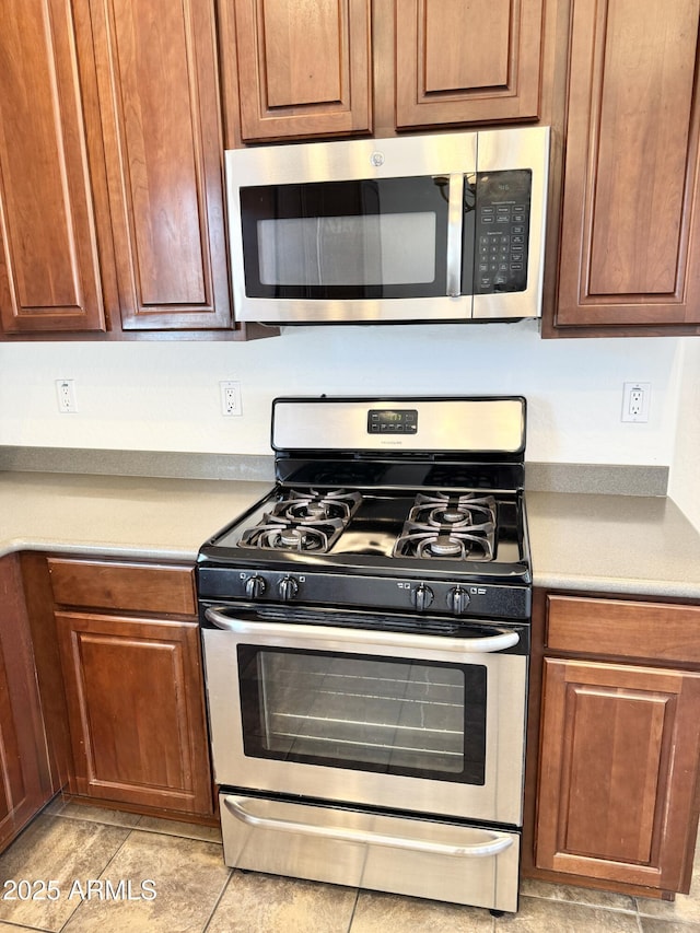 2539 N 148th Dr, Goodyear, AZ 85395 - kitchen featuring appliances with stainless steel finishes, light countertops, and light tile patterned floors