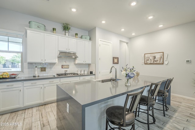 17253 W Echo Ln, Waddell, AZ 85355 - kitchen featuring a sink, stainless steel gas stovetop, light wood-style flooring, backsplash, and recessed lighting