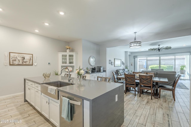 17253 W Echo Ln, Waddell, AZ 85355 - kitchen featuring a sink, light wood-style floors, stainless steel dishwasher, white cabinetry, and recessed lighting