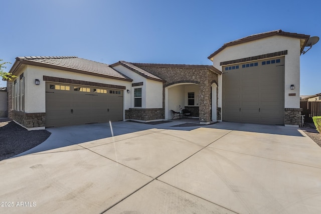17253 W Echo Ln, Waddell, AZ 85355 - single story home with stone siding, driveway, and an attached garage