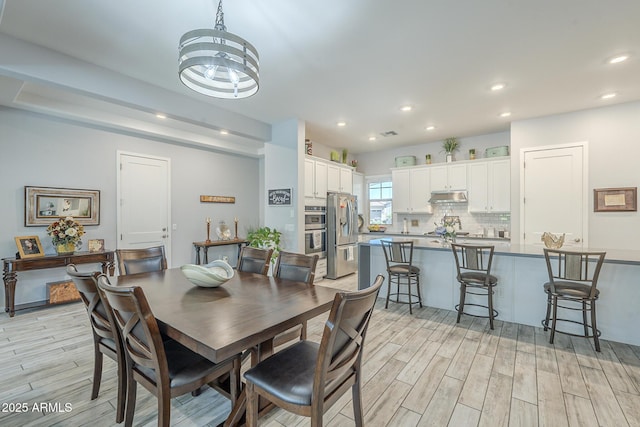17253 W Echo Ln, Waddell, AZ 85355 - dining area with light wood finished floors, recessed lighting, and a chandelier