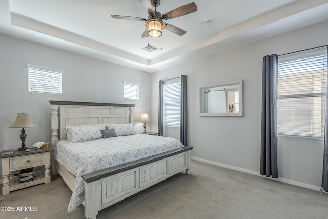 17253 W Echo Ln, Waddell, AZ 85355 - bedroom featuring light carpet, a tray ceiling, and baseboards