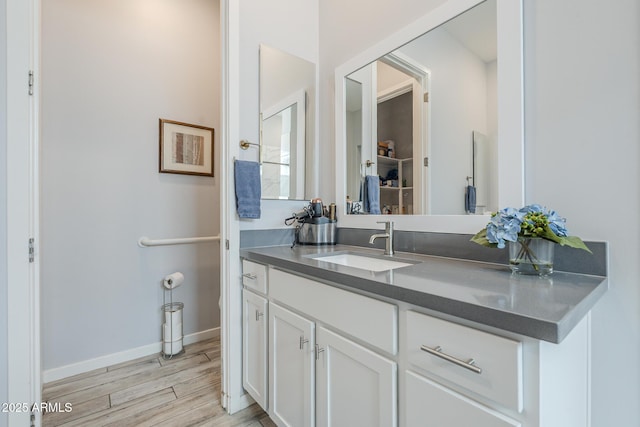 17253 W Echo Ln, Waddell, AZ 85355 - bathroom with wood finished floors, vanity, and baseboards