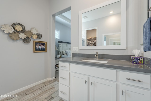 17253 W Echo Ln, Waddell, AZ 85355 - bathroom featuring vanity, wood finished floors, baseboards, and a spacious closet