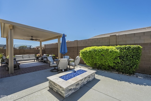 17253 W Echo Ln, Waddell, AZ 85355 - view of patio with an outdoor living space with a fire pit, a fenced backyard, outdoor dining space, and ceiling fan