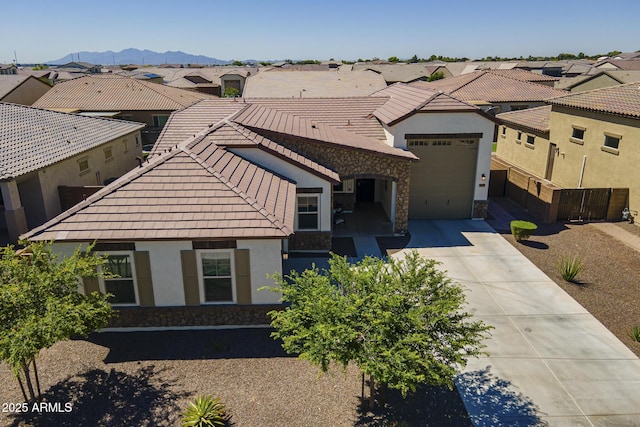17253 W Echo Ln, Waddell, AZ 85355 - view of front of home with driveway, stucco siding, a tiled roof, and a residential view