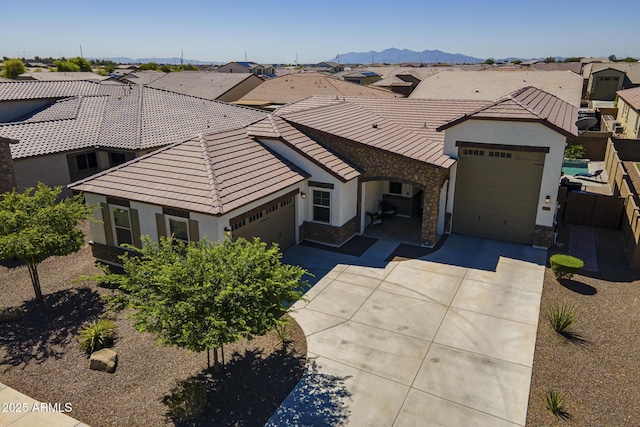 17253 W Echo Ln, Waddell, AZ 85355 - view of front facade with driveway, a garage, stone siding, and a tiled roof