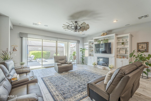 17253 W Echo Ln, Waddell, AZ 85355 - living room featuring recessed lighting, light wood-type flooring, a fireplace, and baseboards