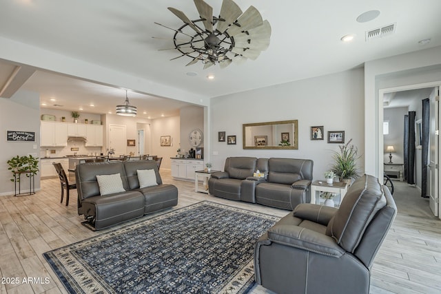 17253 W Echo Ln, Waddell, AZ 85355 - living area featuring light wood finished floors, recessed lighting, and a ceiling fan