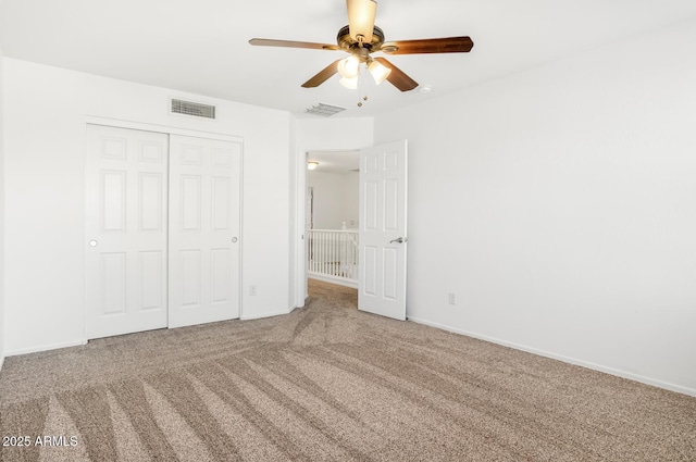 unfurnished bedroom featuring carpet flooring, ceiling fan, and a closet