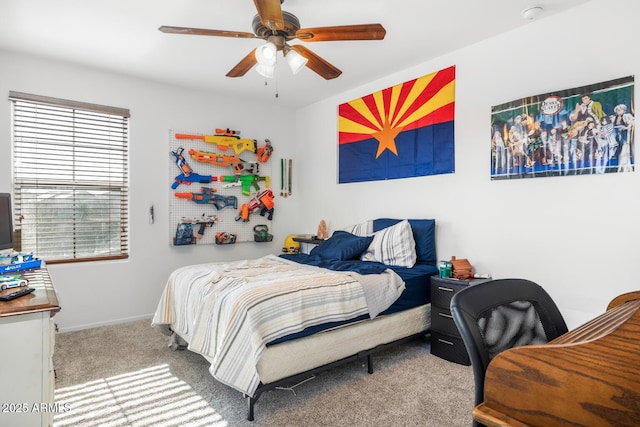 carpeted bedroom featuring multiple windows and ceiling fan