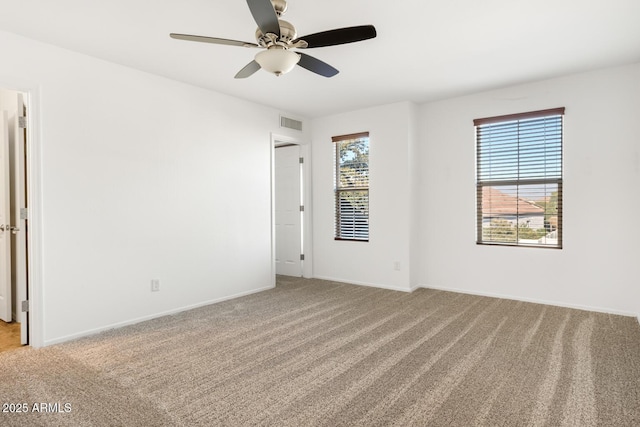 unfurnished room featuring light colored carpet and ceiling fan